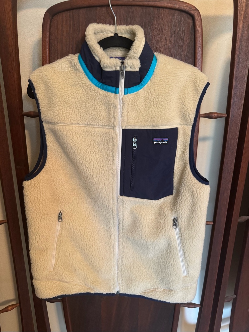 Patagonia Cream Sherpa Vest with Navy Chest Pocket and Turquoise Trim